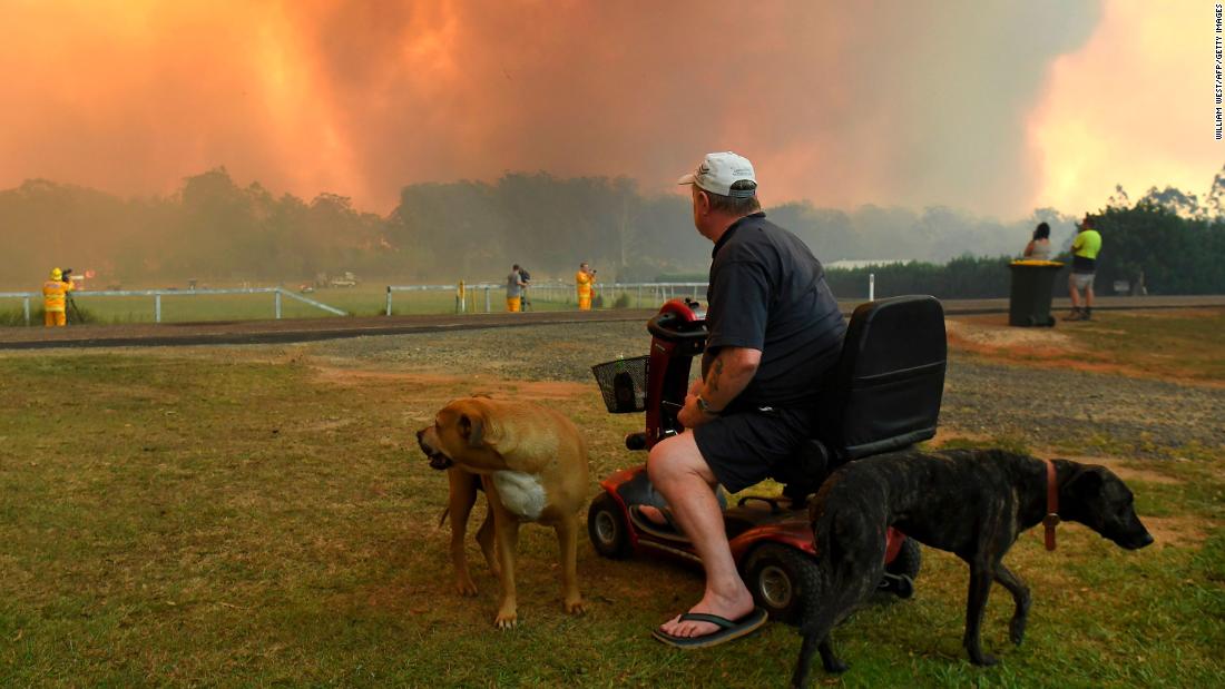 Locals watch the fires impact farmland near Nana Glen on November 12.
