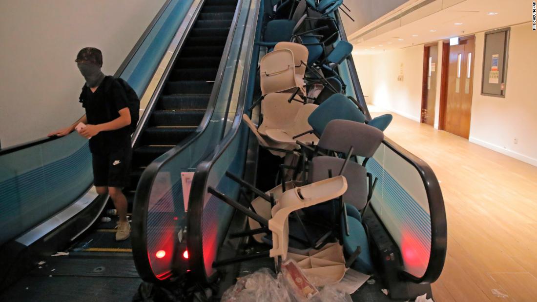 Students block an escalator with chairs in an attempt to hamper police at the University of Hong Kong on November 12.