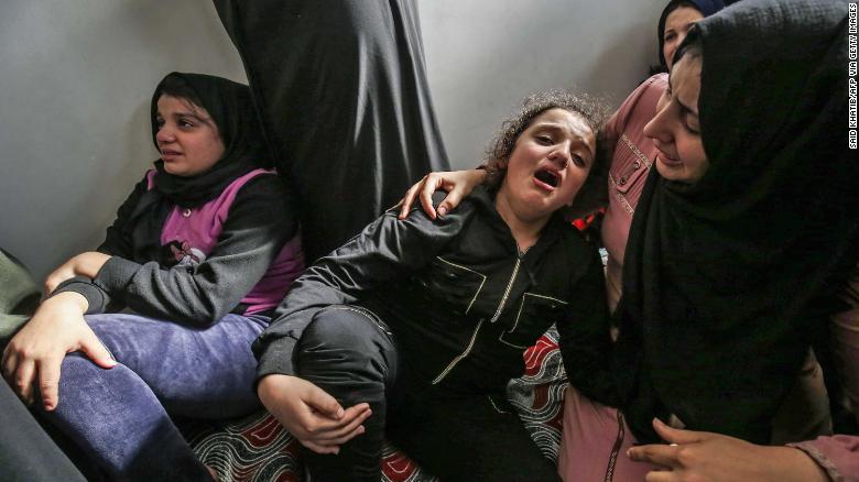 Lian (C) daughter of Baha Abu Al-Ata mourns during his funeral in Gaza City on November 12.