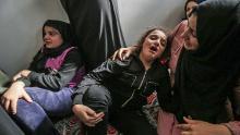 Lian (C) daughter of Baha Abu Al-Ata mourns during his funeral in Gaza City on November 12.