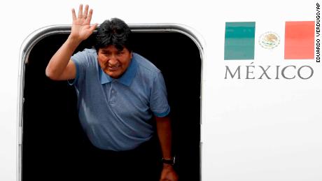 Former Bolivian President Evo Morales waves upon his arrival in Mexico City Tuesday