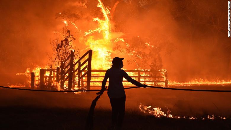 Residents defend a property from a bushfire at Hillsville near Taree, north of Sydney, on November 12.