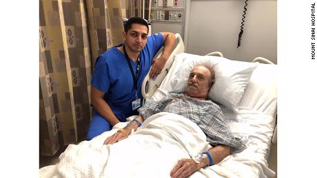 Dr. Nazir Khan and Milton Winger post for a photo after surgery.