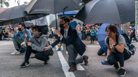 Protesters hold umbrellas as during a standoff with police on November 13, 2019 in Hong Kong&#39;s Central district.