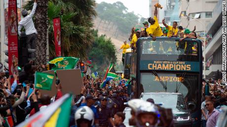 South African rugby captain Siya Kolisi holds the Webb Ellis Cup as he celebrates with thousands of Springbok fans.