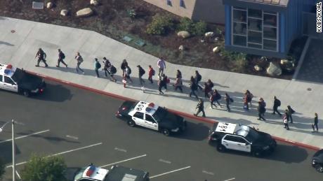 People walk away from the school after the shooting Thursday morning.