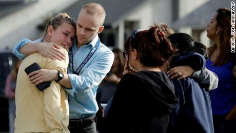 D.J. Hamburger, a teacher at Saugus High School, comforts a student after the shooting.