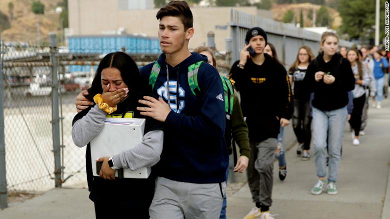 Students are escorted out of Saugus High School after the shooting Thursday.