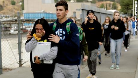 Students are escorted out of Saugus High School after reports of a shooting on Thursday, Nov. 14, 2019, in Santa Clarita, Calif. (AP Photo/Marcio Jose Sanchez)