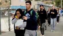 Students are escorted out of Saugus High School after reports of a shooting on Thursday, Nov. 14, 2019, in Santa Clarita, Calif. (AP Photo/Marcio Jose Sanchez)