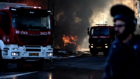 Firefighters at a factory that was hit by a rocket in Sderot, Israel on Tuesday.