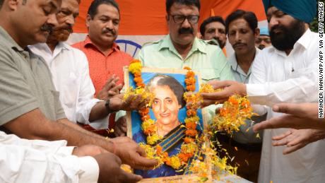 Men pay tribute to former Indian Prime Minister Indira Gandhi, in Amritsar on October 30, 2019.