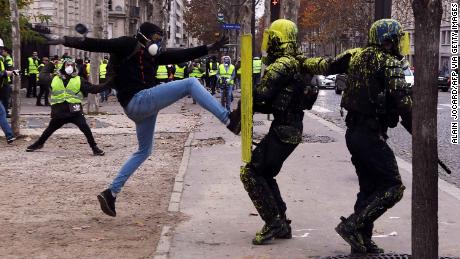 A demonstrator clashes with riot police in Paris, on December 1, 2018.