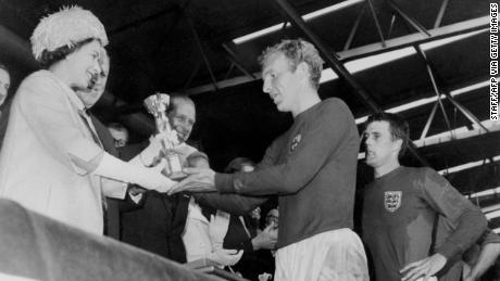 The Queen hands the Jules Rimet Trophy to Bobby Moore after England win the 1966 World Cup final.