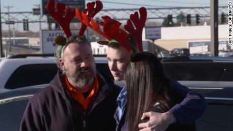 Hank Cazier, center, and his parents at the surprise billboard unveiling in Idaho Falls. 