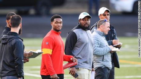NFL scouts watch quarterback Colin Kaepernick during a private NFL workout in Riverdale, Georgia. 