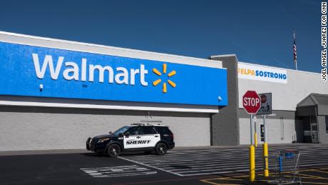 A sheriff's vehicle drives past the Walmart store in Cielo Vista a day after its official reopening on November 14.