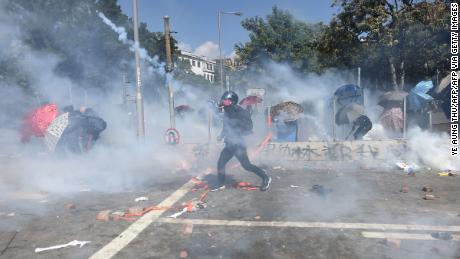 A protester reacts from tear gas fired by police at the Hong Kong Polytechnic University in Hong Kong on Sunday.