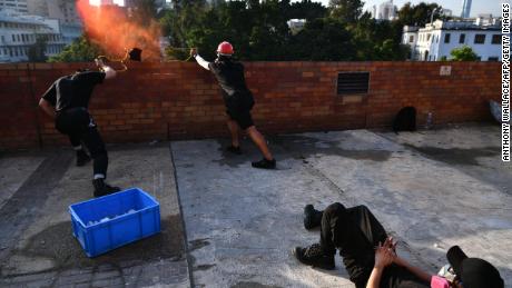 Protesters use a catapult to fire objects at the police from inside the Hong Kong Polytechnic University in Hong Kong on Sunday.