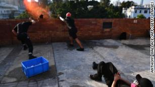 Protesters use a catapult to fire objects at the police from inside the Hong Kong Polytechnic University in Hong Kong on Sunday.