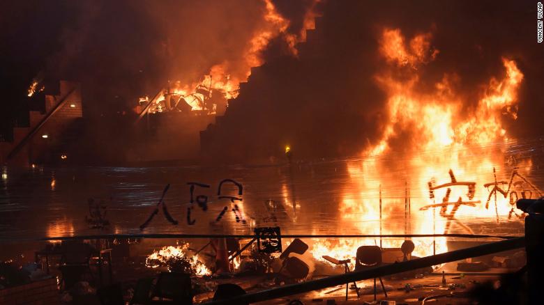 Fires burn at the steps to Hong Kong Polytechnic University as police storm the campus early Monday. 