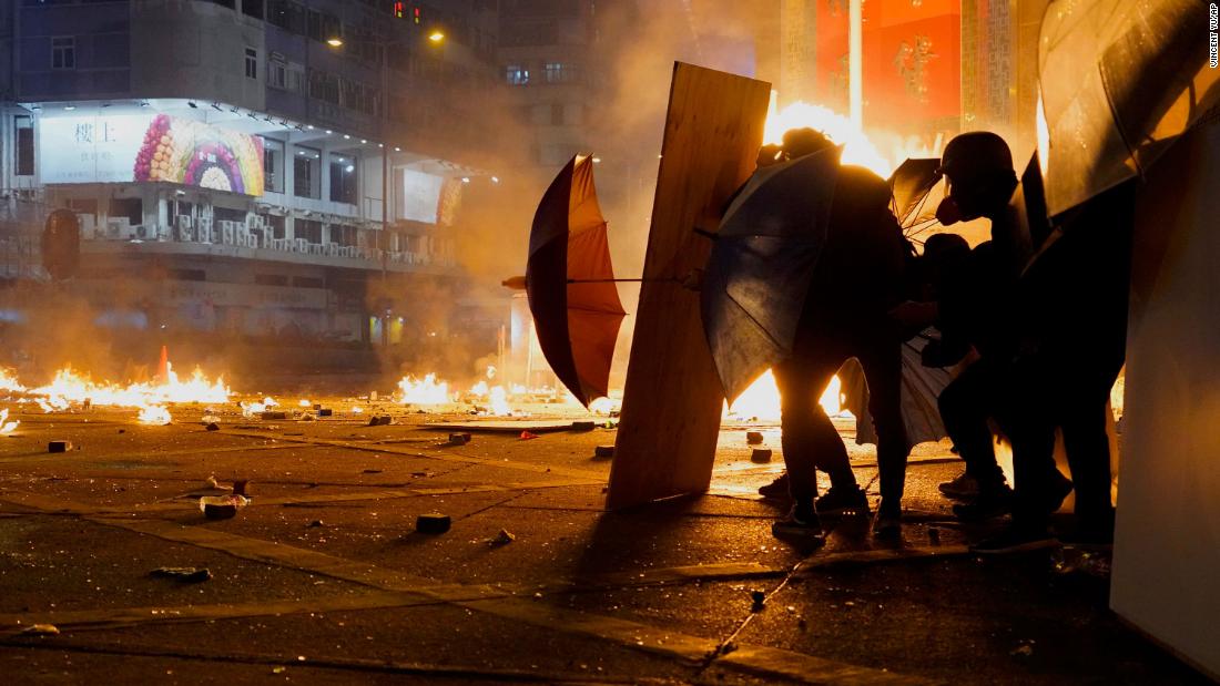 Protesters react as police fire tear gas in the Kowloon area of Hong Kong, Monday, November 18. 