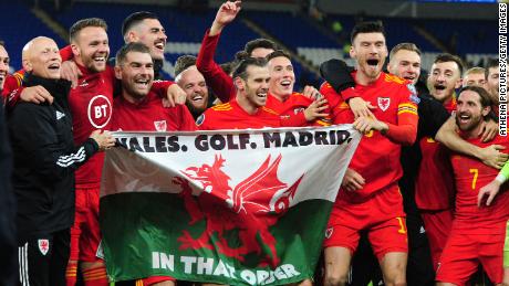 Wales celebrate with the infamous &quot;Wales. Golf. Madrid flag.&quot;