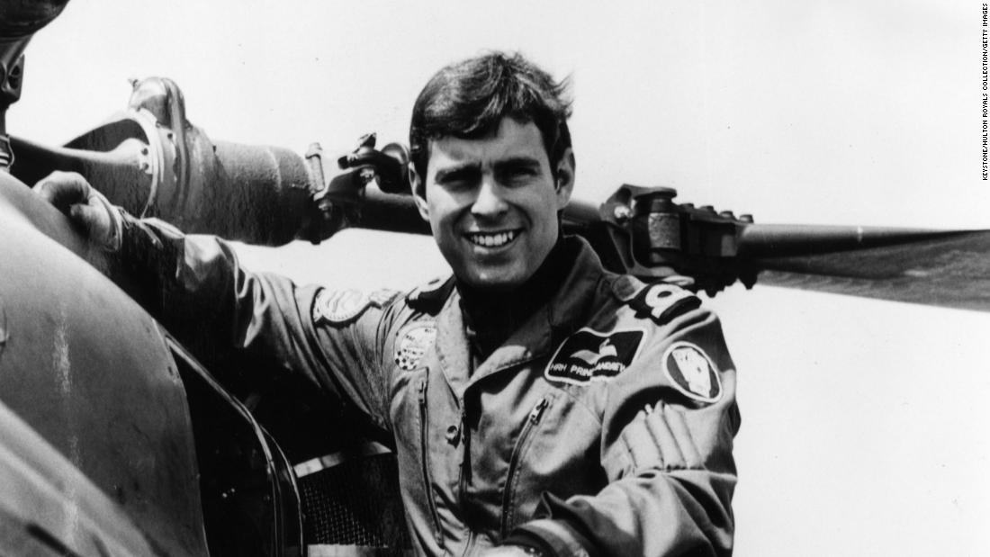 Prince Andrew poses next to a helicopter in 1982.