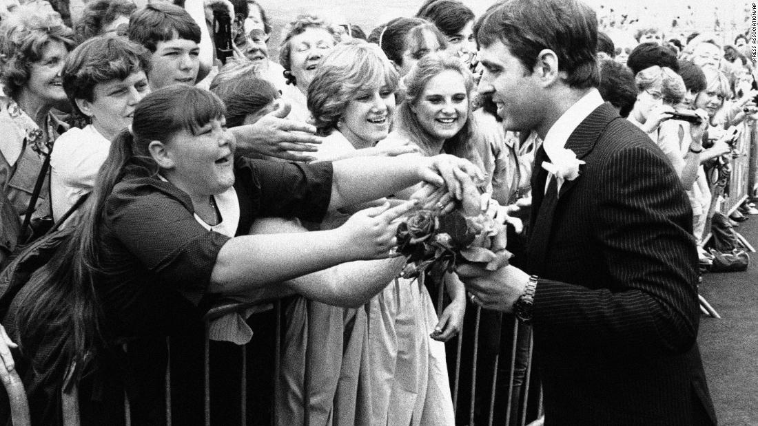 Girls line up to give flowers to Prince Andrew as he arrives in Portsmouth, England, for an event in 1983.