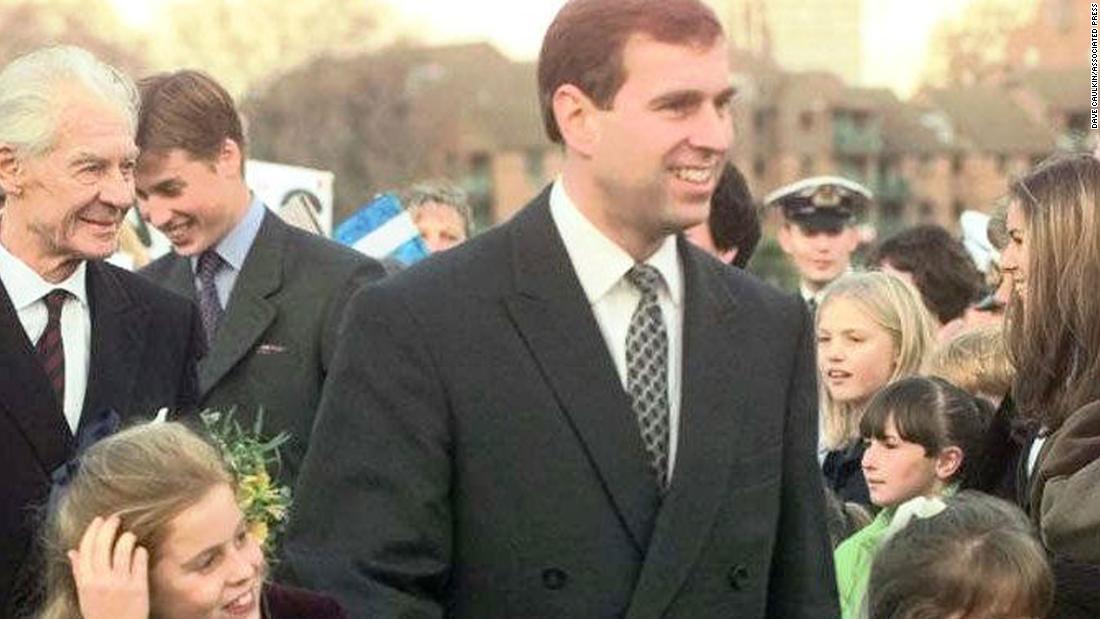 Prince Andrew holds hands with his two daughters, Beatrice and Eugenie, after arriving for a dinner in London in 1997.