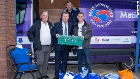 Dave Kelly (L) and former Everton player Graham Stuart collect donations outside Goodison Park.