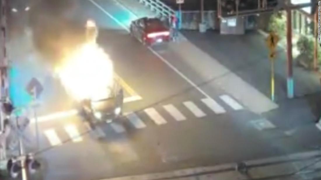 Car explodes in flames at a railroad crossing - CNN Video