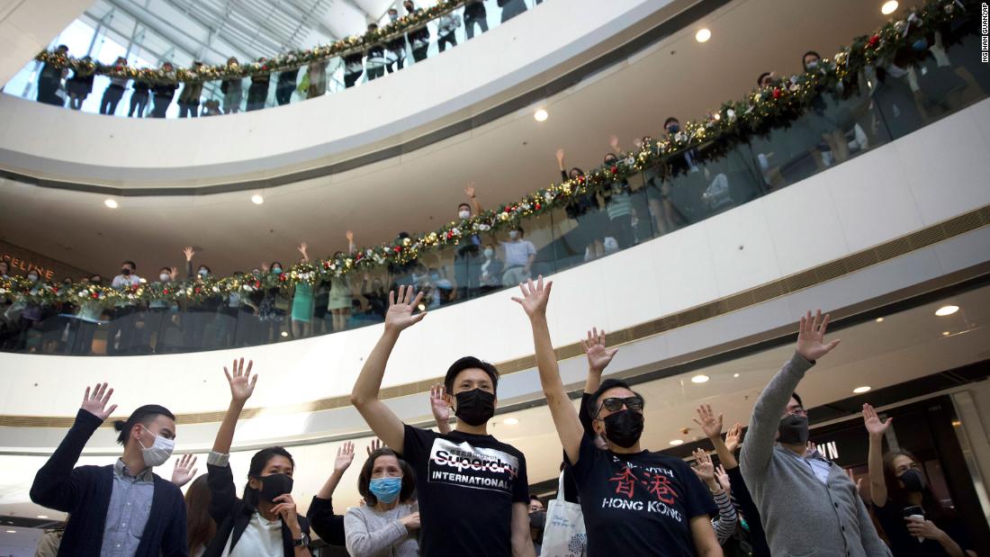 Protesters raise their hands to represent the five demands of pro-democracy demonstrators during a rally in support of the Hong Kong Human Rights and Democracy Act in the U.S., at the IFC Mall in Hong Kong, on November 21.
