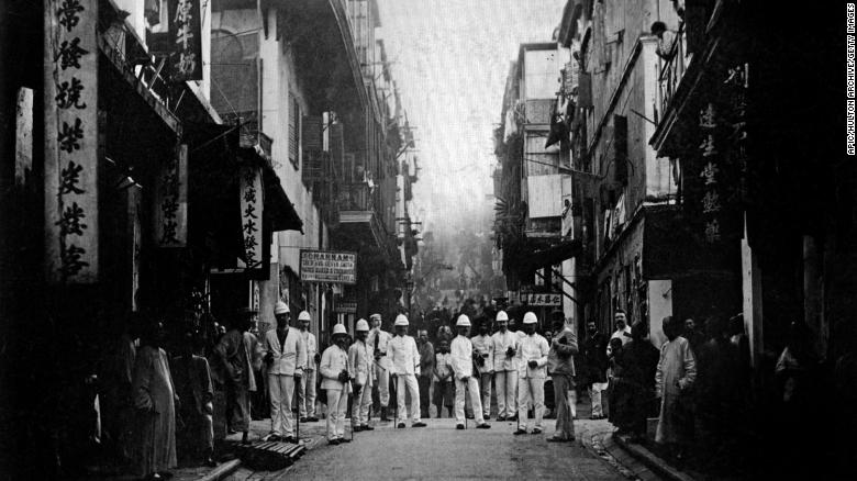 Plague inspectors on a street of Hong Kong, around 1890.