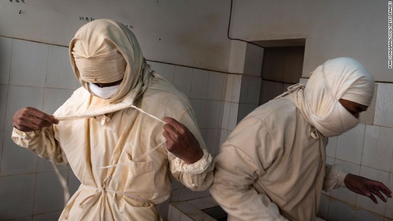 Staff members from a local disease control center wear prevention clothes and masks before entering a plague surveillance lab in Sichuan Province of China in August 28, 2019. 