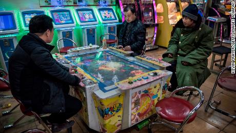 Chinese men play video games at an arcade on January 20, 2015 in central Beijing.