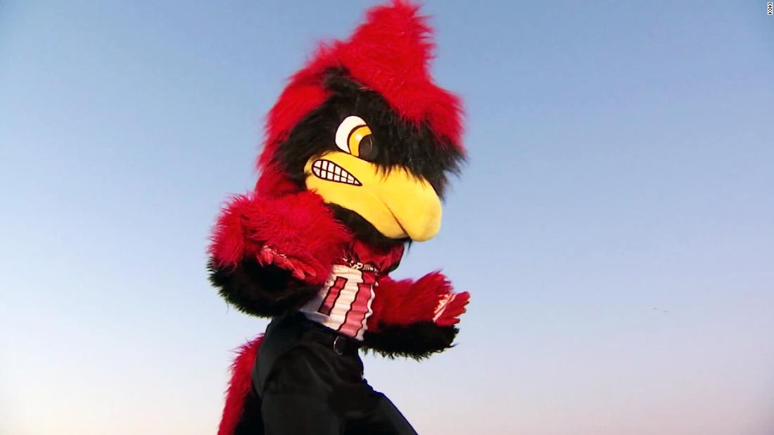 Cartoon Cardinal School Mascot Playing Soccer or Football Stock