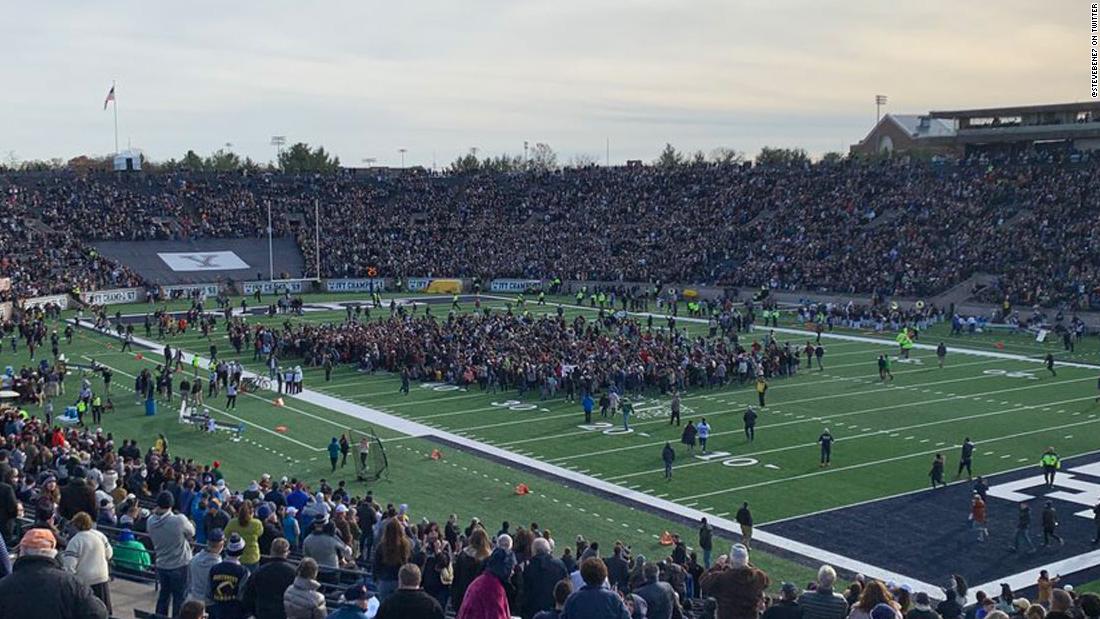 The Harvard-Yale football game was delayed after students and alumni stormed the field to protest climate change