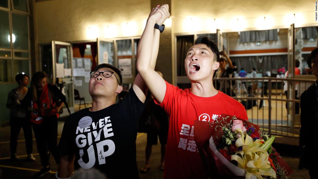 Pro-democracy candidate Jimmy Sham, right, celebrates with a supporter after winning his election in the Sha Tin district, early November 25. &quot;Today's result represents (my constituency's) support to protesters. The government should immediately establish the Five Demands and respond to the public's voices,&quot; Sham posted on Facebook, referencing a long-standing protest slogan.