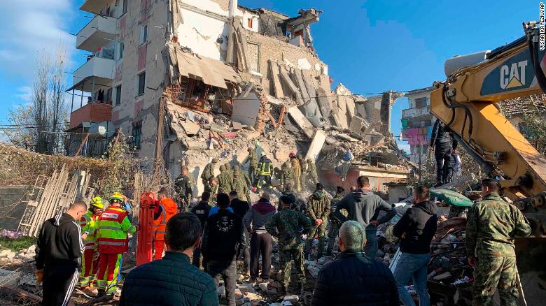 Rescuers search a damaged building in Thumane, Albania on Tuesday morning.
