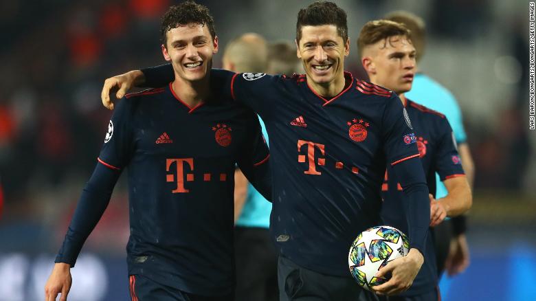 Robert Lewandowski is congratulated by Bayern teammate Benjamin Pavard.