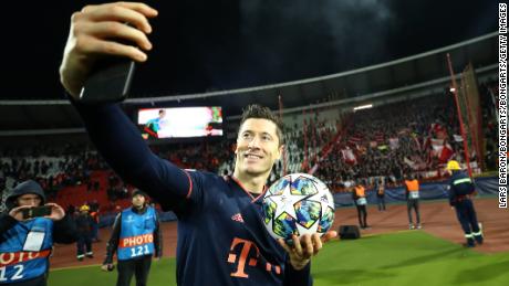 Robert Lewandowski takes a selfie with his match ball after scoring his third hat trick of the season.