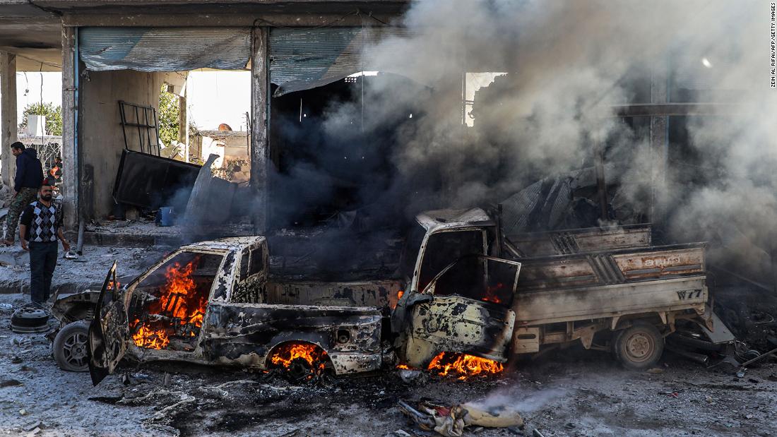 A car burns following a car bomb explosion in Tal Abyad, a city in northern Syria near the Turkey border, on Saturday, November 23.