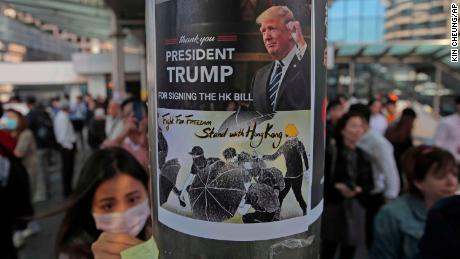 Protesters stick a poster featuring US President Donald Trump on a pillar during a demonstration in Central, the financial district of Hong Kong.