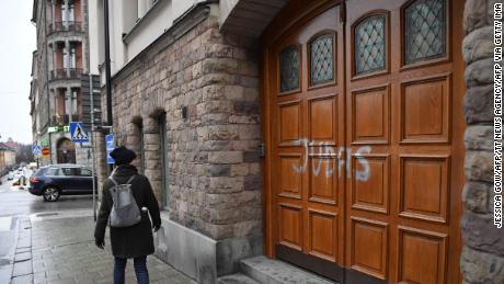 A woman walks past Swedish football player Zlatan Ibrahimovic&#39;s property in Stockholm, where someone sprayed &quot;Judas&quot; on the the door.