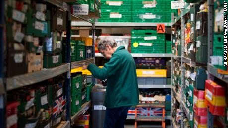 A volunteer at a Trussell Trust food bank sorts out the stock.