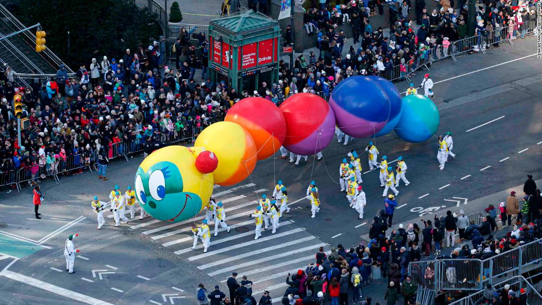 A colorful caterpillar balloon floats during the parade.