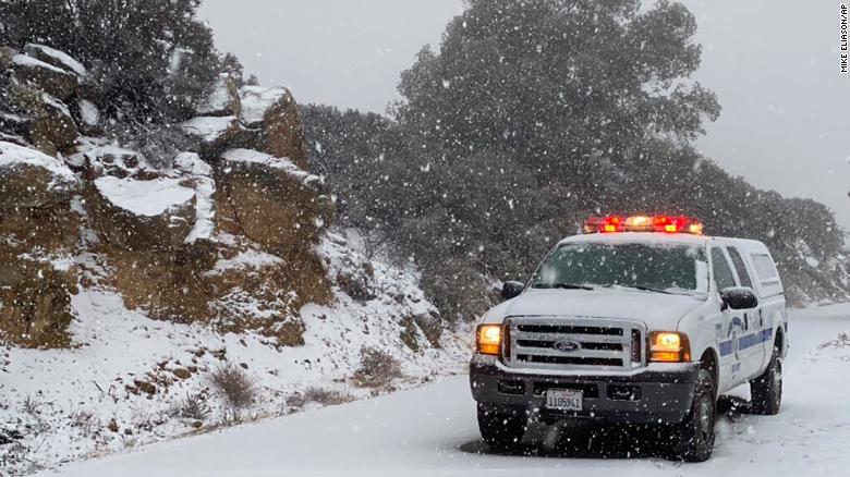 This photo tweeted by the Santa Barbara County Fire Department shows a Santa Barbara Fire Department truck along E. Camino Cielo as snow falls at the 3,500 foot level on the fire footprint in Santa Barbara, California, on Thursday, November 28, 2019