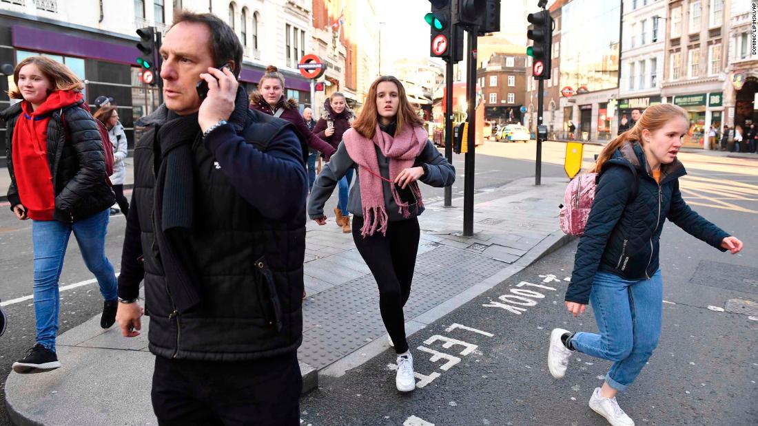 People rush away from Borough Market after police told them to leave the area.
