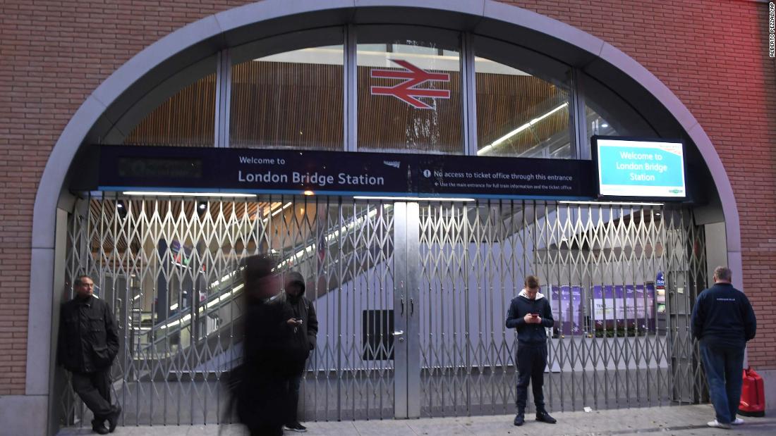 People stand outside the London Bridge Station after it was closed.